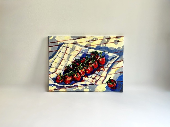Tomatoes scattered across a folded blue and white cloth.