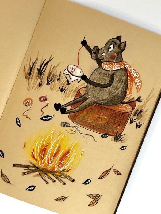 Sketchbook page: a boar in a scarf sitting beside a campfire.
