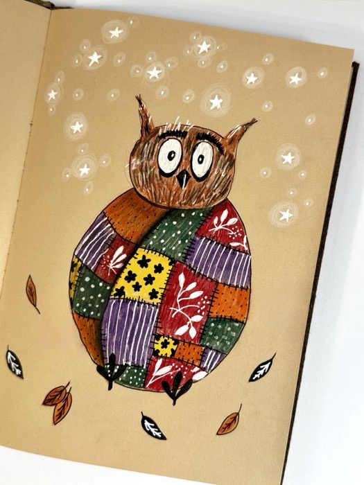 Sketchbook page: an owl with a patchwork blanket under a sky of stars.